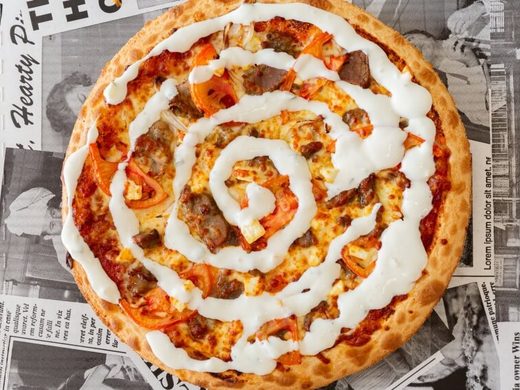 Souva pizza with seasoned lamb and a swirl of tzatziki